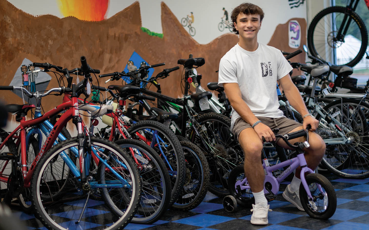 Photo of teen posing in front of bikes